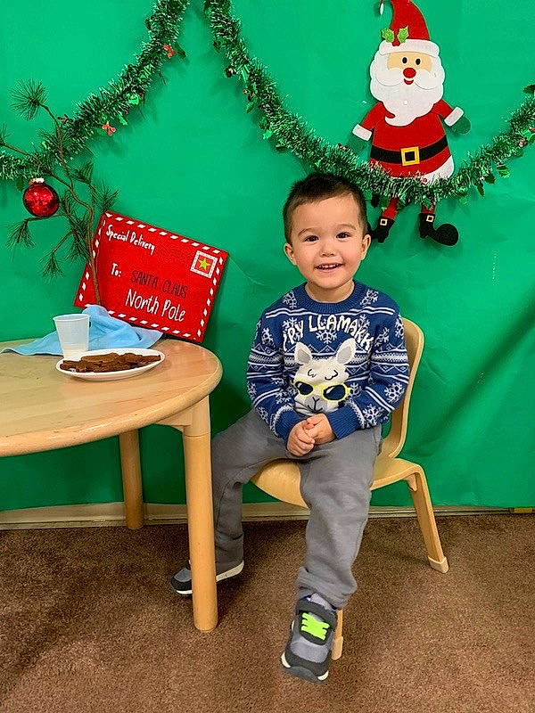 Peter joined the competition — help win amazing prizes! baby_toddler_clothing, christmas, christmas_decoration, christmas_eve, christmas_ornament, christmas_tree, costume_hat, fictional_character, green, holiday, holiday_ornament, joy, ornament, party_supply, person, sitting, sock, table, wreath