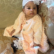 Arzahnya joined the competition — help win amazing prizes! baby, child, infant, couch, fur_coat, headband, flower, dress, shoes, patterned_fabric, sitting, cute, portrait, indoor, person, fashion, adorable, young_child, accessory, soft_texture
