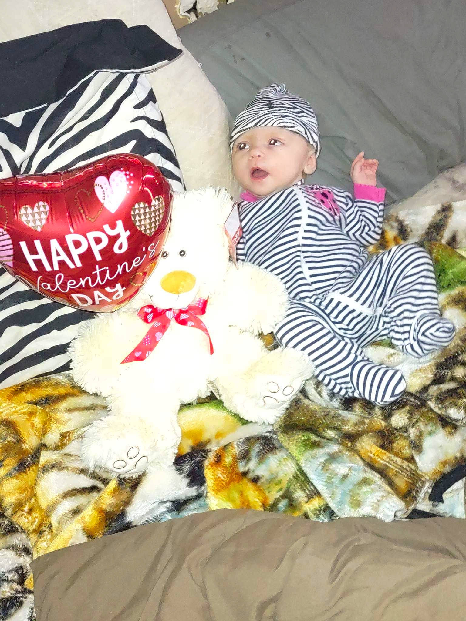 Aspen is registered to the contest to win money with this photo: baby_toddler_clothing, cap, carmine, christmas, doll, event, fashion_accessory, fawn, fur, headwear, knit_cap, linens, mammal, pattern, person, plush, room, stuffed_toy, textile, toy