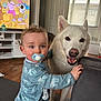 Rowan joined the competition — help win amazing prizes! toddler, child, dog, pacifier, living_room, television, cartoon, furniture, floor, window, door, clothing, smile, pet, indoor, curtains, wood_floor, baby, playtime, companion