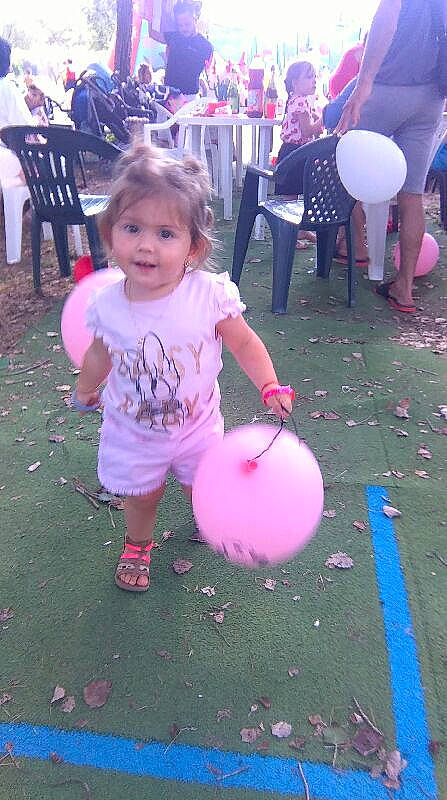 Selena participe au concours pour gagner de l'argent avec cette photo : balloon, chair, clothing, event, fun, happy, human_body, leg, leisure, magenta, people, person, photograph, pink, purple, recreation, shorts, smile, t_shirt, toddler