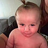 Mateo joined the competition — help win amazing prizes! baby, child, ponytail, blanket, couch, person, indoor, face, skin, hair, expression, curious, young, infant, holding, comfort, seated, adult, family, home