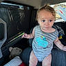 Mateo joined the competition — help win amazing prizes! baby, child, car_interior, car_seat, onesie, gray_clothing, blue_print, tousled_hair, seat, cushion, window, sunshade, toy, stuffed_animal, infant, person, young_child, looking_away, casual, indoor