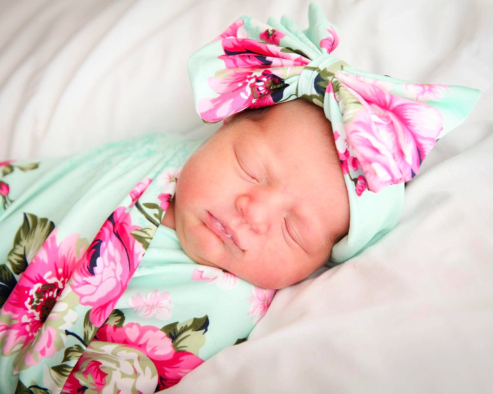Vivian is registered to the contest to win money with this photo: baby, baby_sleeping, baby_toddler_clothing, bedding, child, comfort, dress, fashion_accessory, grass, headband, headpiece, headwear, linens, magenta, pattern, person, petal, pink, rose, sleeve