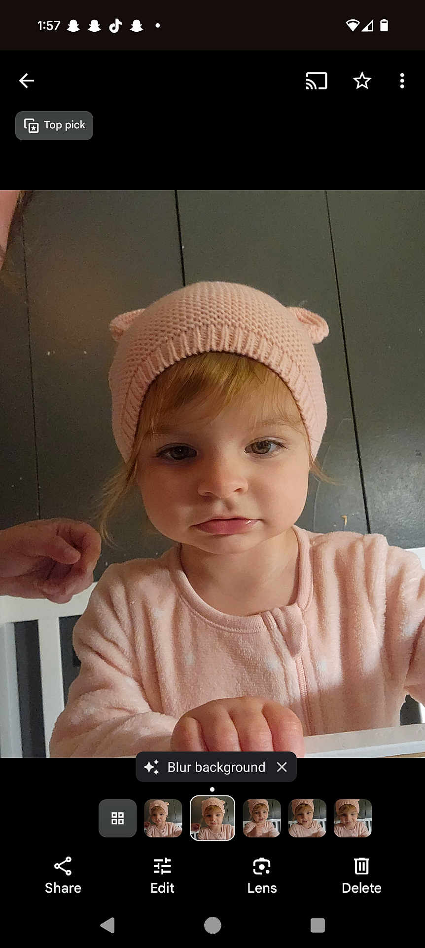 Tiffany is registered to the contest to win money with this photo: toddler, child, pink_hat, knit_hat, baby, cute, face, portrait, indoor, hand, clothing, railing, looking, young_child, person, expression, headwear, soft_lighting, closeup, curious