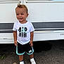 Taysem participe au concours pour gagner de l'argent avec cette photo : toddler, child, boy, smile, standing, white_tshirt, shorts, sneakers, hair, outdoor, vehicle, asphalt, side_view, playful_hair, casual_clothing, daylight, person, happy, fashion, feet