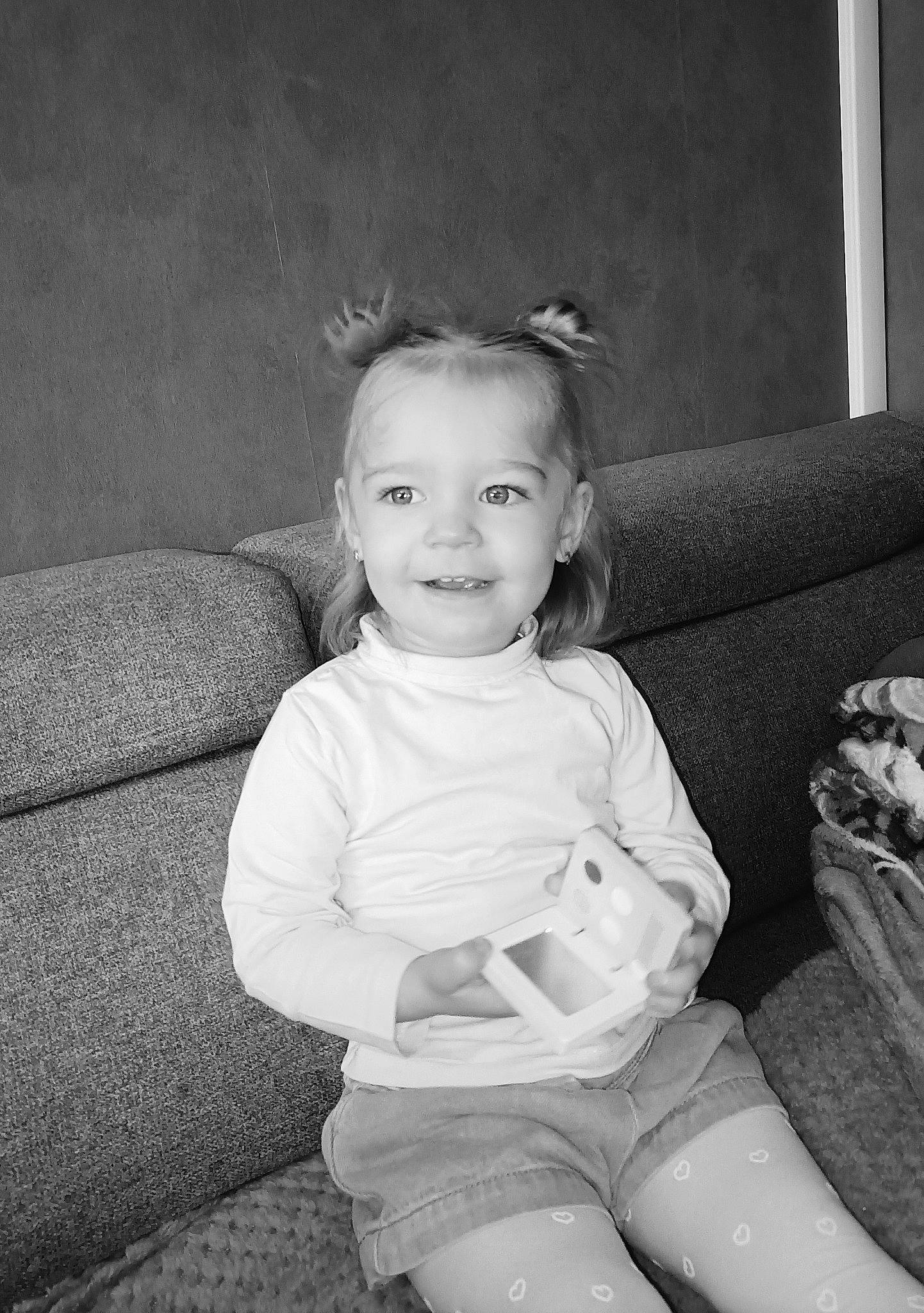 Annaëlle a rejoint le concours — aidez-le/la à gagner de superbes lots ! baby_toddler_clothing, black, black_and_white, blond, child, comfort, facial_expression, flash_photography, fun, happy, human_leg, iris, joy, monochrome, monochrome_photography, person, sitting, smile, standing, style