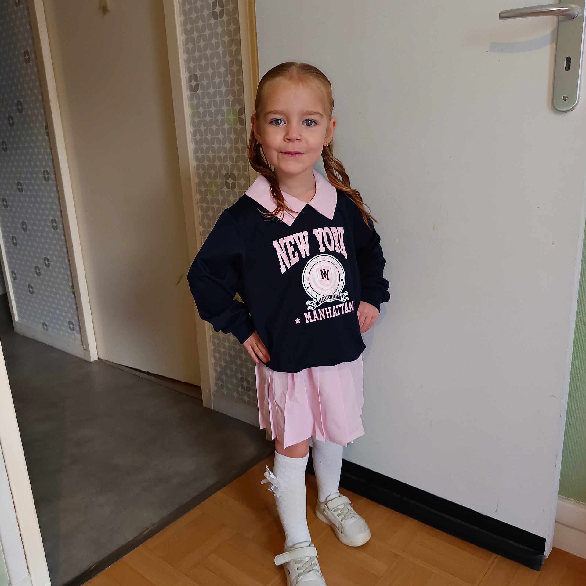 Annaëlle participe au concours pour gagner de l'argent avec cette photo : braids, child, clothing, confident, door, dress, floor, girl, hallway, home, indoor, person, portrait, pose, shoes, smile, socks, standing, sweatshirt, wallpaper