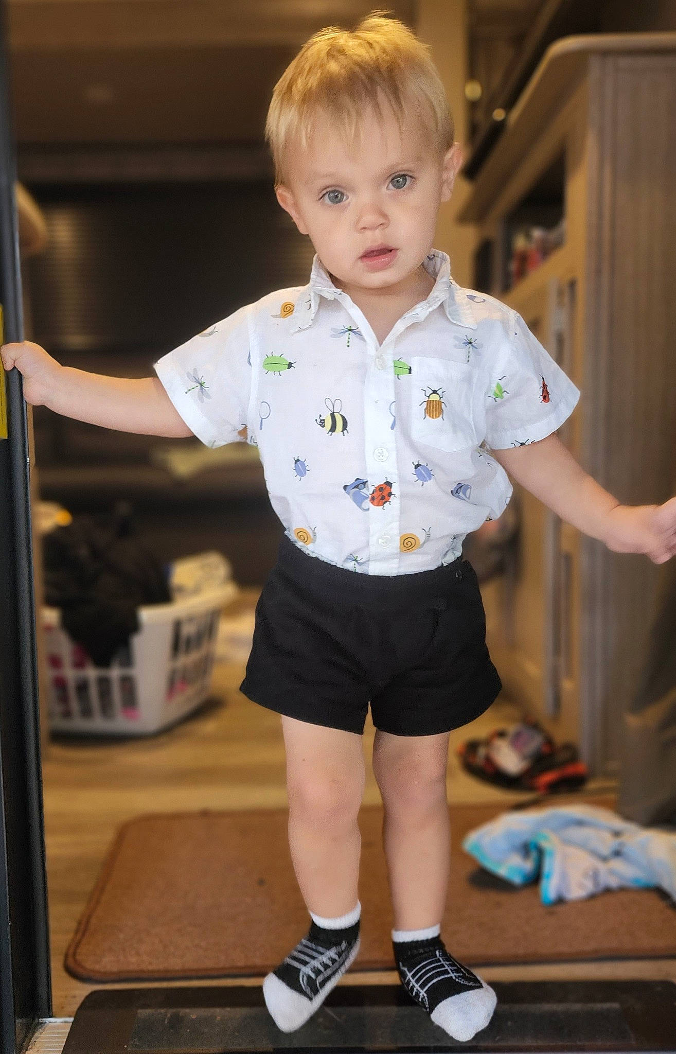Zeke is registered to the contest to win money with this photo: baby, baby_toddler_clothing, blond, child, electric_blue, flooring, fun, happy, human_leg, knee, pattern, person, play, room, shorts, sitting, sleeve, standing, t_shirt, table