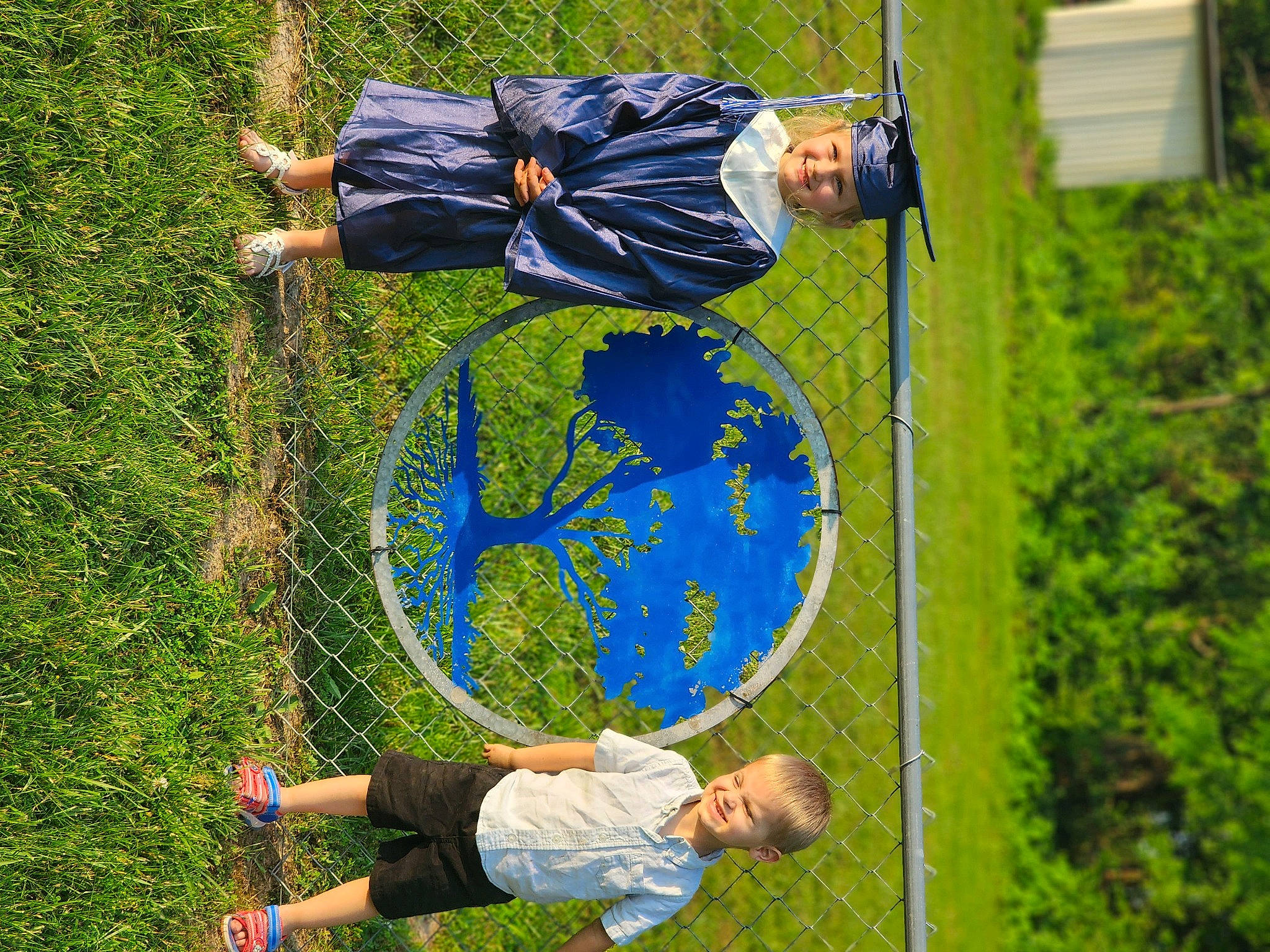 Zeke is registered to the contest to win money with this photo: balance, clothing, competition_event, fun, grass, grassland, green, headwear, joy, lawn, leisure, nature, people_in_nature, person, plant, playing_sports, recreation, shorts, sneakers, sports