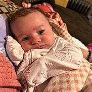 Paisleigh joined the competition — help win amazing prizes! baby, blanket, couch, indoor, infant, person, face, clothing, comfort, patterned, soft, warm, child, resting, closeup, portrait, cute, cozy, head, eyes