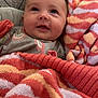 Paisleigh is registered to the contest to win money with this photo: baby, infant, blanket, striped_blanket, clothing, cute, face, expression, portrait, indoor, cozy, smile, child, newborn, soft, warm, happy, knit, head, person