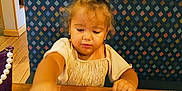 Novalynn is registered to the contest to win money with this photo: toddler, child, girl, curly_hair, dining, restaurant, table, chip, salsa, food, fork, napkin, cup, booth, patterned_backrest, wooden_table, purple_purse, earrings, casual_clothing, indoor