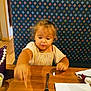 toddler, child, girl, curly_hair, dining, restaurant, table, chip, salsa, food, fork, napkin, cup, booth, patterned_backrest, wooden_table, purple_purse, earrings, casual_clothing, indoor