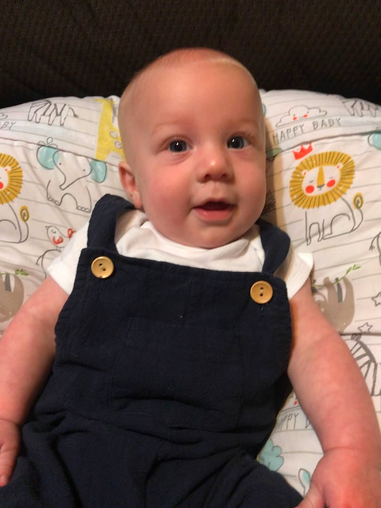 Bryer is registered to the contest to win money with this photo: arm, baby, baby_safety, baby_toddler_clothing, cheek, child, collar, comfort, eye, fun, happy, linens, outerwear, pattern, person, room, sitting, skin, sleeve, t_shirt