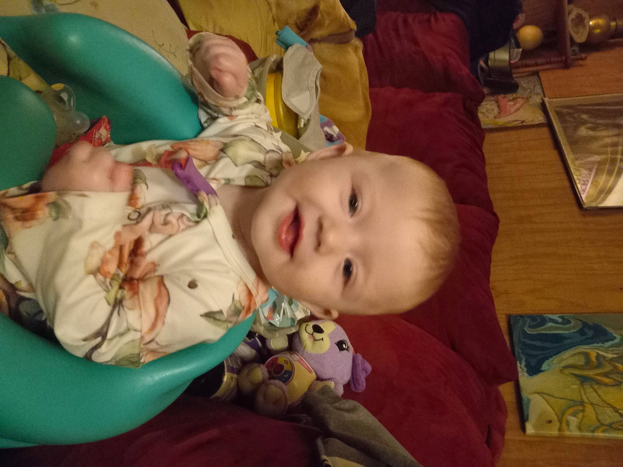 Thora is registered to the contest to win money with this photo: baby, baby_products, baby_toddler_clothing, cheek, child, comfort, flooring, fun, happy, iris, joy, kitchen_utensil, mouth, nose, person, room, sitting, skin, smile, tableware