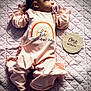October joined the competition — help win amazing prizes! baby, infant, one_month, pacifier, pink_outfit, headband, bow, quilted_blanket, milestone_marker, newborn, cute, child, lying_down, soft_lighting, portrait, indoors, sleepwear, feet, hand, face