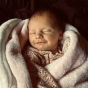 October is registered to the contest to win money with this photo: baby, sleeping, blanket, soft, floral_pattern, cozy, infant, wrapped, peaceful, cute, newborn, child, face, portrait, comfort, warm, rest, indoors, toddler, smile