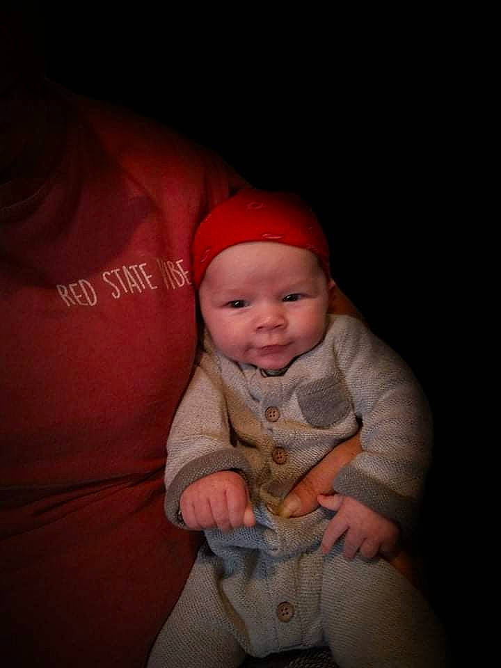 Jacob is registered to the contest to win money with this photo: baby, baby_products, baby_toddler_clothing, baseball_cap, cap, chin, comfort, darkness, flash_photography, headgear, headwear, human_leg, lip, mouth, nose, person, personal_protective_equipment, sleeve, smile, t_shirt