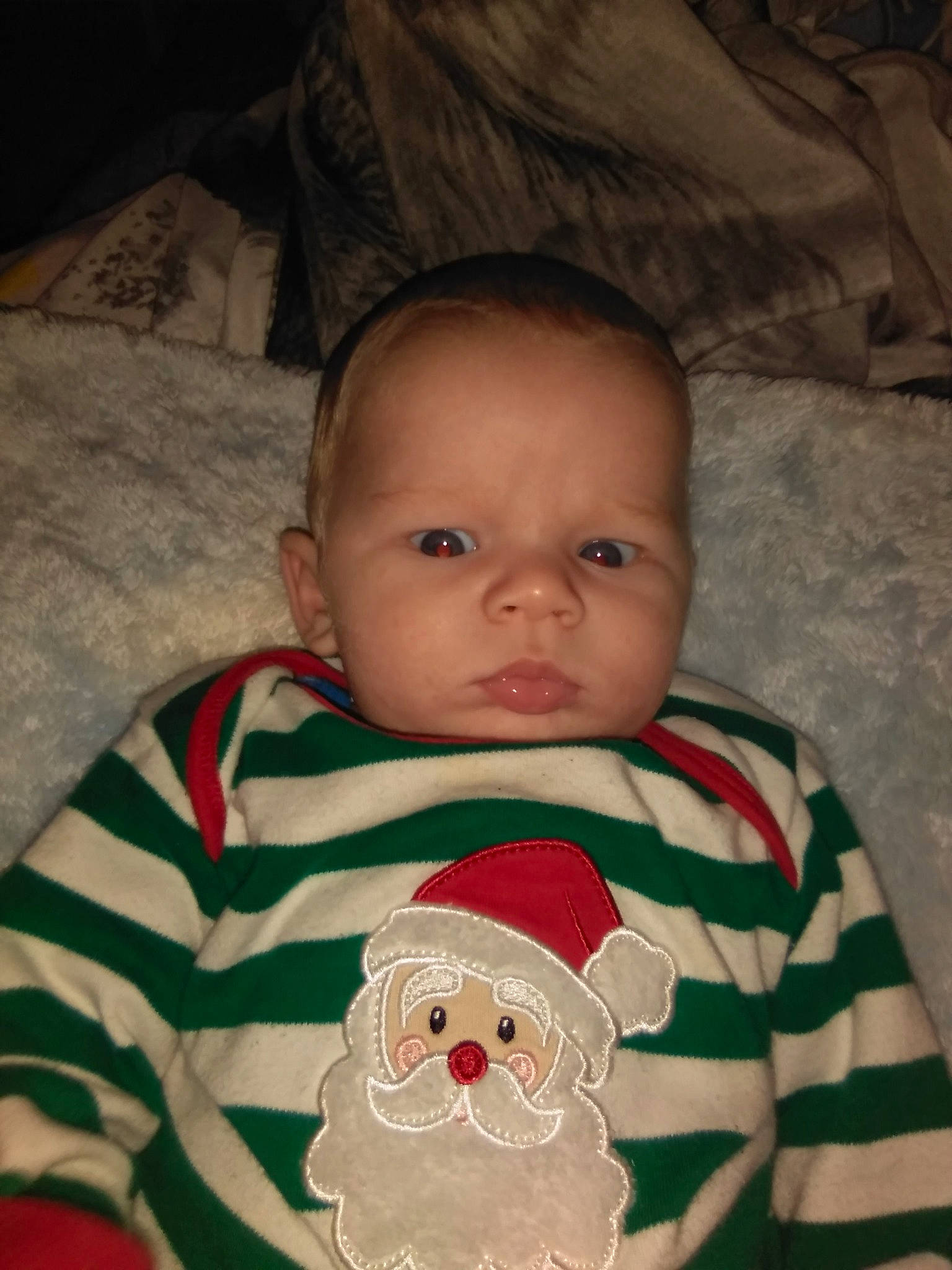 Jacob is registered to the contest to win money with this photo: baby, baby_toddler_clothing, carmine, cheek, child, christmas, comfort, eye, happy, head, holiday, iris, linens, nose, organ, person, sitting, skin, sleeve, t_shirt