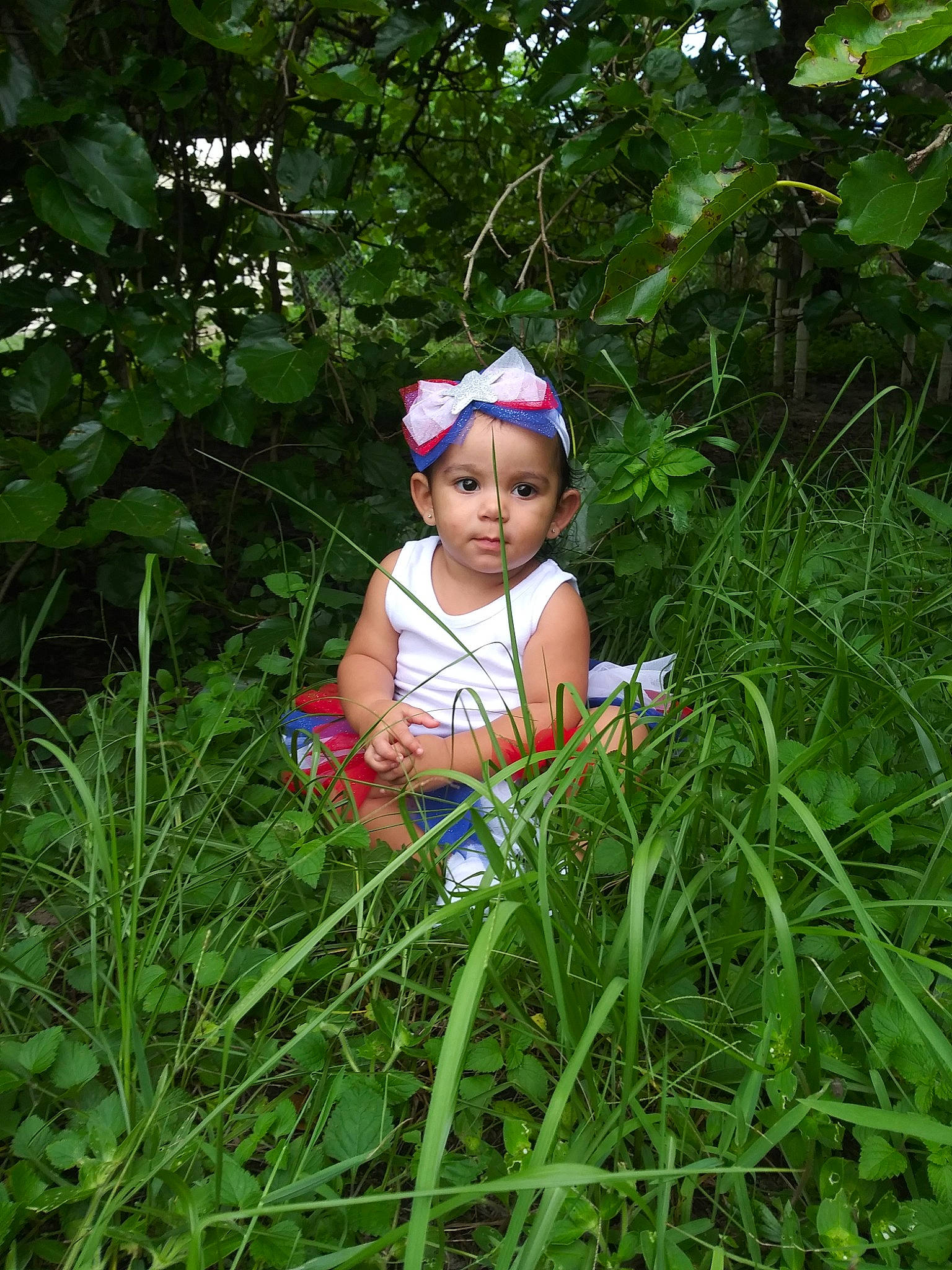Marlie is registered to the contest to win money with this photo: adaptation, botany, child, fawn, flower, grass, grass_family, green, headgear, jungle, meadow, person, plant, plant_community, smile, terrestrial_plant, toddler, vacation, wildflower