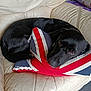animal, black_dog, comfort, couch, cozy, curled_up, dog, domestic, face, floor, fur, home, indoor, leather, looking, pet, pillow, resting, sleepy, union_jack