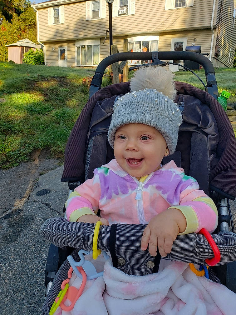 Maliyah joined the competition — help win amazing prizes! baby, baby_carriage, baby_products, baby_toddler_clothing, fun, grass, headwear, house, joy, leisure, person, personal_protective_equipment, plant, product, recreation, smile, tire, toddler, travel, tree