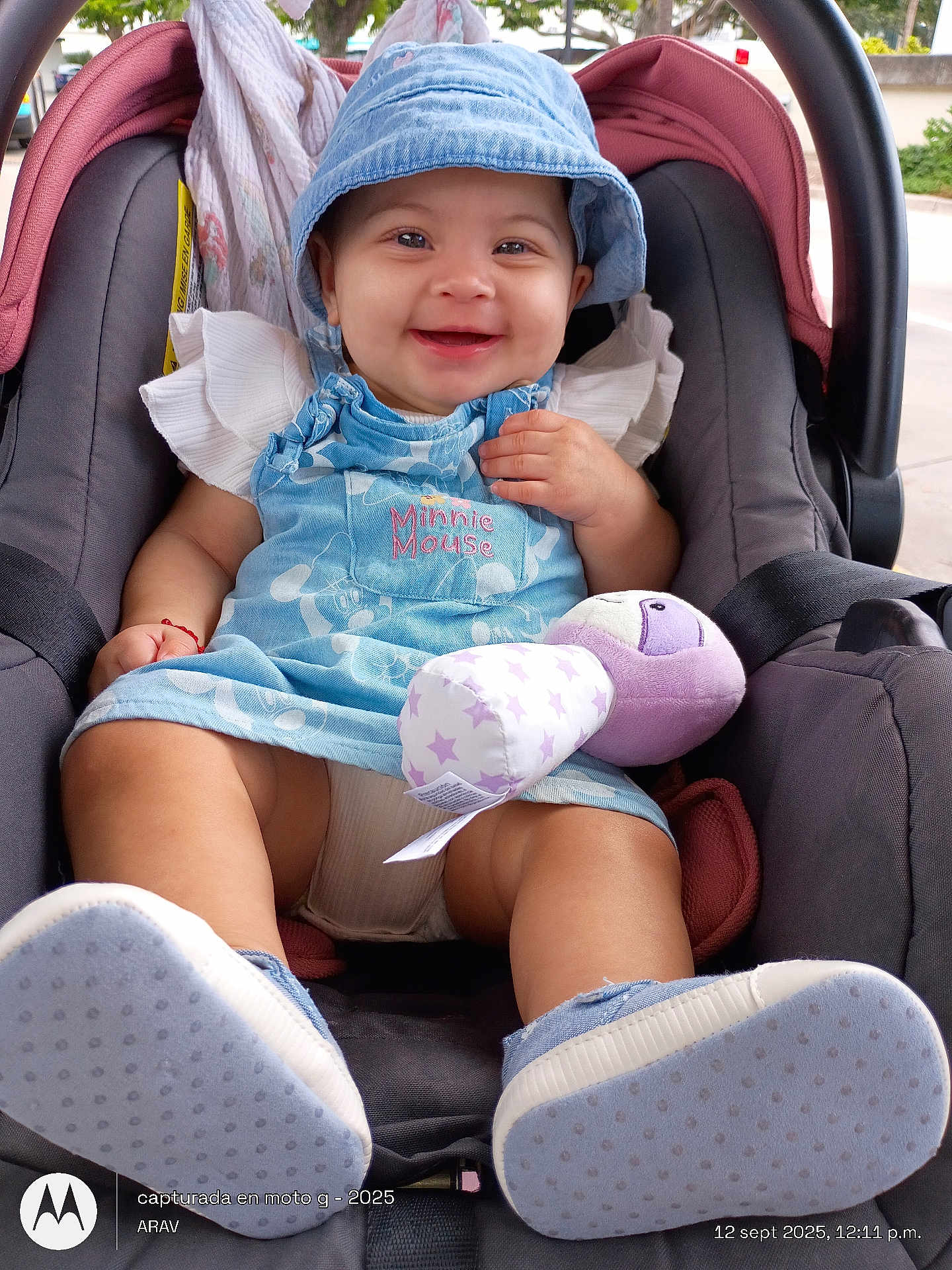 Blanca joined the competition — help win amazing prizes! baby, smiling, car_seat, plush_toy, blue_hat, dress, child, outdoor, footwear, happy, infant, person, seatbelt, cute, portrait, clothing, toy, sitting, daylight, accessory