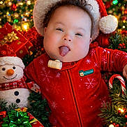R.j. is registered to the contest to win money with this photo: baby, infant, christmas, holiday, santa_hat, red_clothing, tongue_out, plush_snowman, christmas_lights, gift_boxes, festive, smiling, greenery, ornaments, pine_cones, cute, indoors, celebration, portrait, holiday_decor