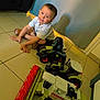 Tiago a rejoint le concours — aidez-le/la à gagner de superbes lots ! boy, candid, casual_clothing, child, combine_harvester, curtain, floor, furniture, happy, home, indoor, playing, shadow, short_hair, smile, tile_floor, toy, tractor, vehicle, white_shirt
