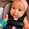 Gracia is registered to the contest to win money with this photo: baby, infant, car_seat, pacifier, pink_headband, blue_eyes, child, seatbelt, cute, closeup, face, straps, clothing, sitting, portrait, young_child, indoor, safety, adorable, infancy