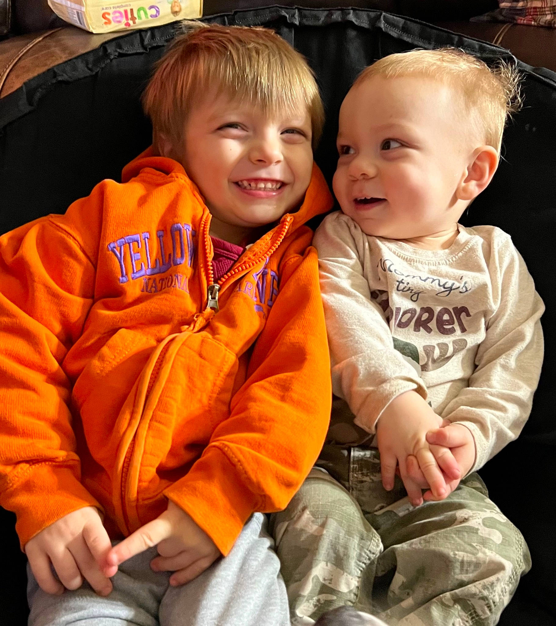 Aiden joined the competition — help win amazing prizes! baby, baby_toddler_clothing, child, event, facial_expression, fun, grass, happy, head, joy, lap, laugh, orange, person, sibling, sitting, skin, sleeve, smile, toddler