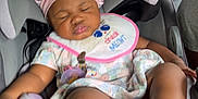 Khyla joined the competition — help win amazing prizes! baby, bib, car_seat, child, child_safety, cute, fabric, floral_outfit, footwear, infant, pacifier, person, pink_bonnet, pouty_face, seatbelt, sleeping, toddler, transparent_shoes, vehicle_interior, window