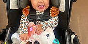 Wynter joined the competition — help win amazing prizes! accessories, baby, clothing, coat, costume, face, happy, head, jacket, person, photography, plush, portrait, sitting, smile, stroller, t_shirt, toy, transportation, vehicle