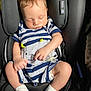 Jahkarri is registered to the contest to win money with this photo: baby, infant, sleeping, car_seat, onesie, striped_clothing, pacifier, socks, child, cute, resting, seat_belt, head_support, small_hands, closed_eyes, soft_lighting, indoor, comfort, newborn, peaceful
