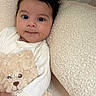baby, teddy_bear, cuddle, soft_texture, cushion, white_clothing, infant, portrait, indoors, cozy, cute, child, smile, face, plush_toy, comfort, young_child, close_up, happy, resting