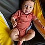 Revan joined the competition — help win amazing prizes! baby, child, infant, onesie, chair, yellow, black, curly_hair, cute, smiling, indoors, person, human, skin, legs, arms, feet, seated, happy, casual_clothing