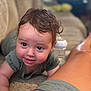 Revan is registered to the contest to win money with this photo: baby, infant, smiling, curly_hair, carpet, couch, bottle, indoor, person, child, face, arm, leg, clothing, baby_bottle, closeup, happy, home, floor, portrait