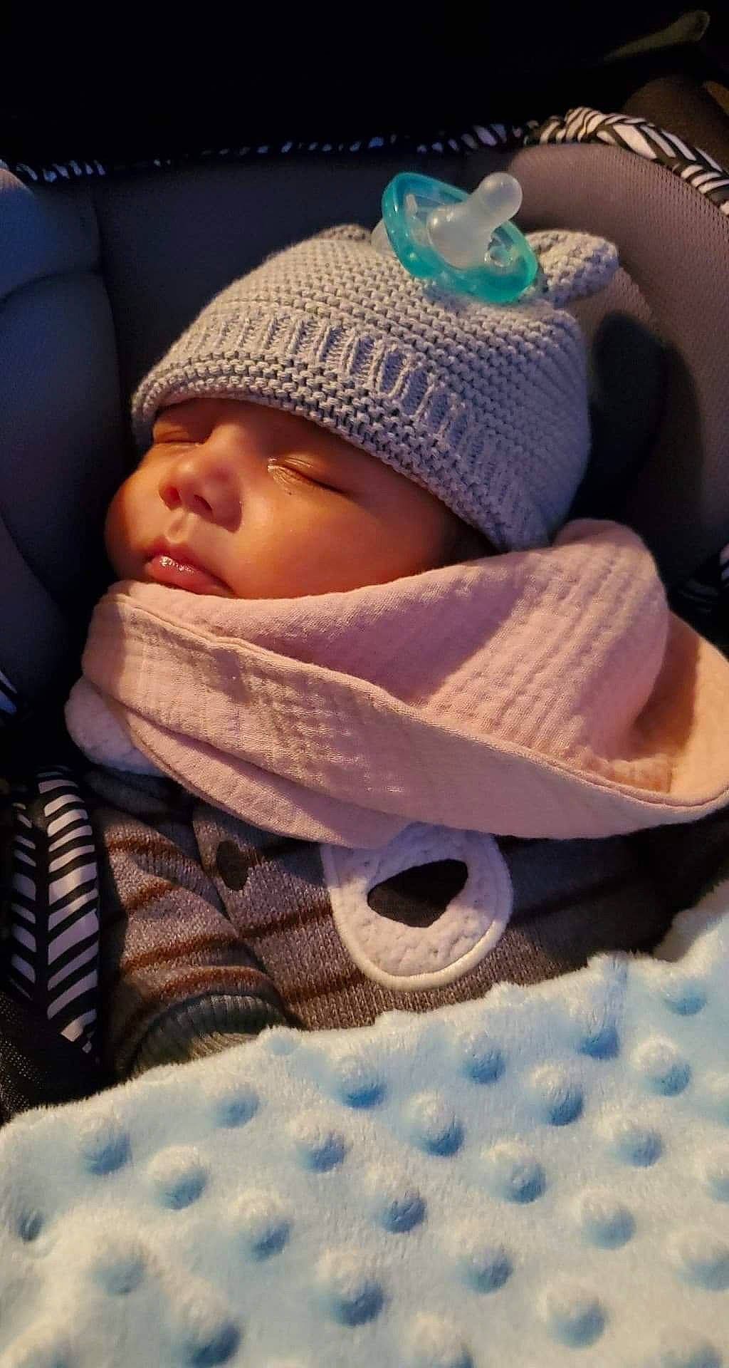 Sheldon is registered to the contest to win money with this photo: baby, baby_products, baby_safety, baby_sleeping, baby_toddler_clothing, beanie, bedtime, cap, cheek, child, comfort, fashion_accessory, knit_cap, linens, product, sitting, skin, toddler, wool, woolen