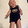 baby, infant, smiling, romper, football_emblem, blanket, white, cute, chubby_cheeks, lying_down, hands, legs, socks, skin, happy, child, portrait, indoors, closeup, person