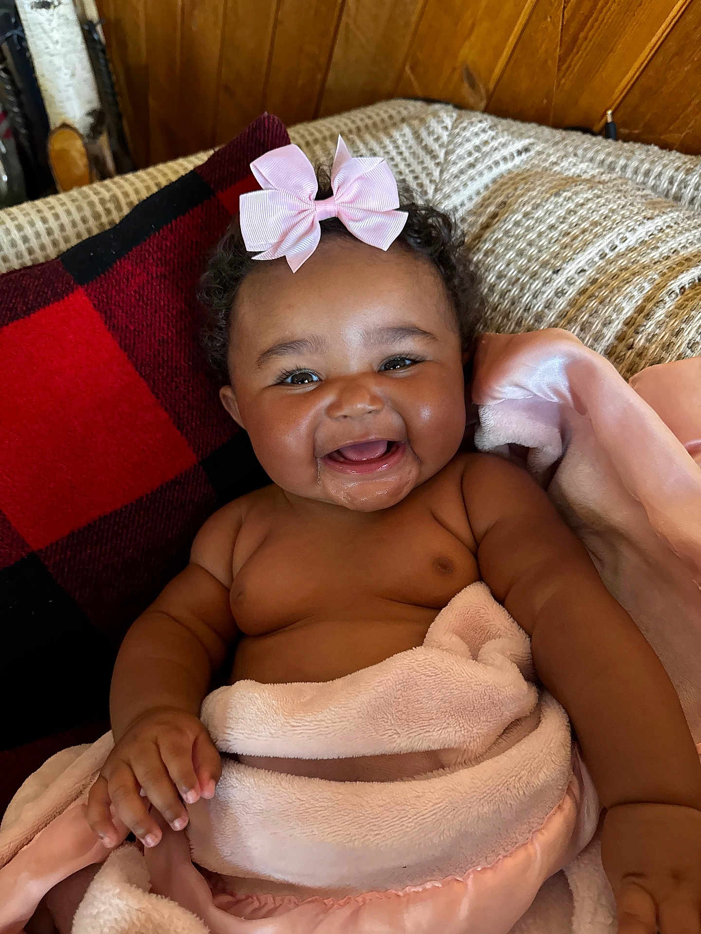 Zalayna is registered to the contest to win money with this photo: baby, blanket, cheeks, child, couch, cozy, curly_hair, cute, drool, happy, indoors, infant, pillow, pink_bow, portrait, red_and_black, relaxing, skin, smiling, toddler