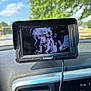 Lainey is registered to the contest to win money with this photo: baby, car_seat, device_screen, dashboard, car_interior, child, outdoor, trees, sky, clouds, technology, screen, infant, seatbelt, window, blur, daytime, display, monitor, carplay
