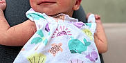 Laynie is registered to the contest to win money with this photo: newborn, baby, infant, smile, sleeping, onesie, clothing, person, resting, lap, cute, peaceful, soft, skin, face, head, arm, hand, blurred_background, indoors