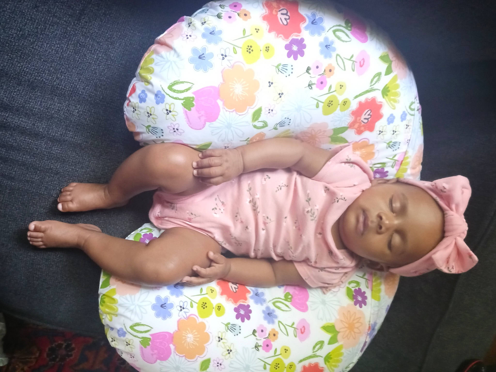 Kamiyah is registered to the contest to win money with this photo: baby, baby_products, baby_sleeping, baby_toddler_clothing, child, comfort, fashion_accessory, hand, headgear, human_body, lap, leg, linens, pattern, person, pink, sitting, sleeve, thigh, toddler