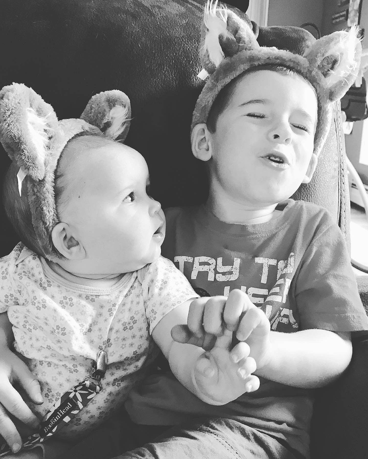 Gwynevere is registered to the contest to win money with this photo: baby, black_and_white, child, ear, facial_expression, fun, gesture, happy, headgear, interaction, monochrome, monochrome_photography, people, person, photograph, photography, smile, snapshot, stock_photography, toddler