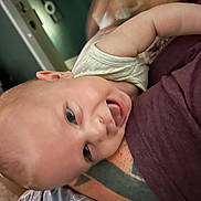 Charlie joined the competition — help win amazing prizes! baby, infant, child, portrait, close_up, face, eyes, wide_eyed, smiling, happy, lying_down, upside_down, being_held, adult, clothing, blanket, indoor, home, warm_lighting, photography