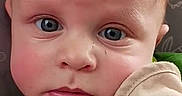 Charlie joined the competition — help win amazing prizes! baby, infant, child, portrait, close_up, face, eyes, blue_eyes, serious, looking_at_camera, green_clothing, cushion, chair, indoor, patterned_background, head, skin, photography, sitting, adorable