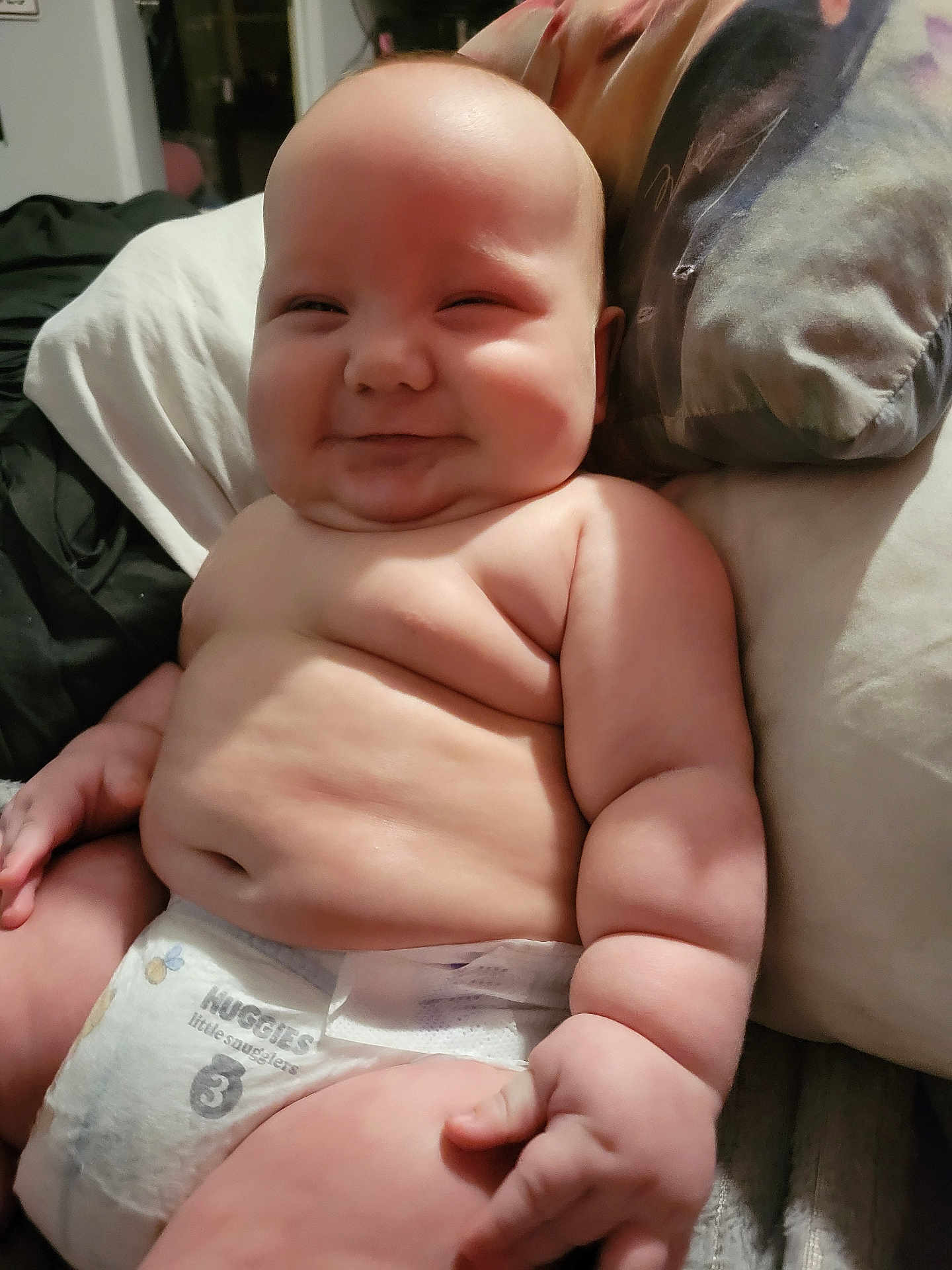 Gunner is registered to the contest to win money with this photo: baby, infant, diaper, smile, chubby, skin, pillow, bed, cute, child, cute_face, happy, plump, rolls, person, indoors, resting, flesh, newborn, cuddly