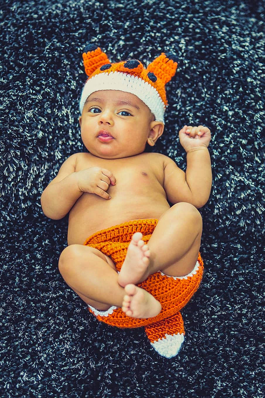 Ritham is registered to the contest to win money with this photo: art, baby, beanie, cap, child, child_model, headgear, headwear, knit_cap, orange, person, smile, toddler, yellow