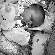 Mia is registered to the contest to win money with this photo: baby, sleeping, plush_toy, unicorn, blanket, cozy, infant, face, hand, soft_toy, monochrome, cute, peaceful, bed, fabric, child, portrait, resting, indoors, comfort
